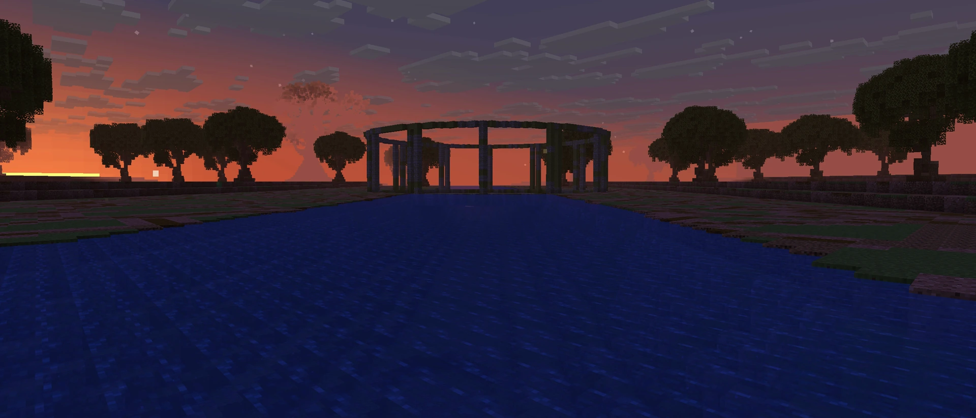 Dreamen at dusk: a still river running between dark trees to the ring of the sunken shrine, the sky orange where the sun went down